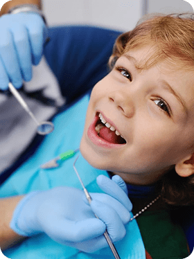 Children's dentist examining young patient at Inspire Dental